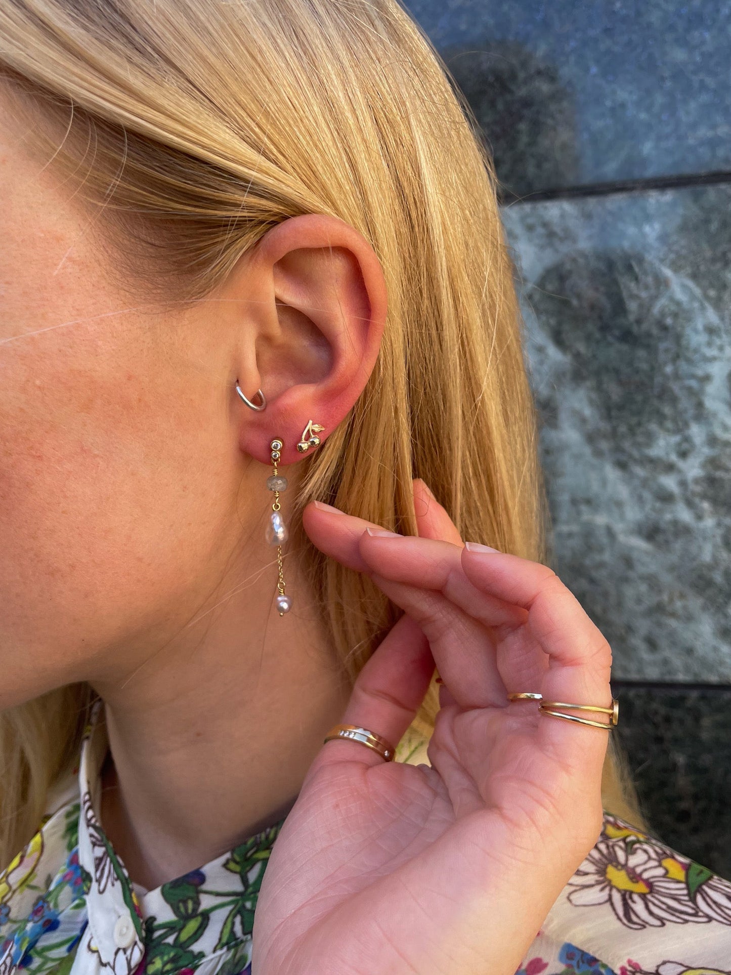 A gold cherry stud earring