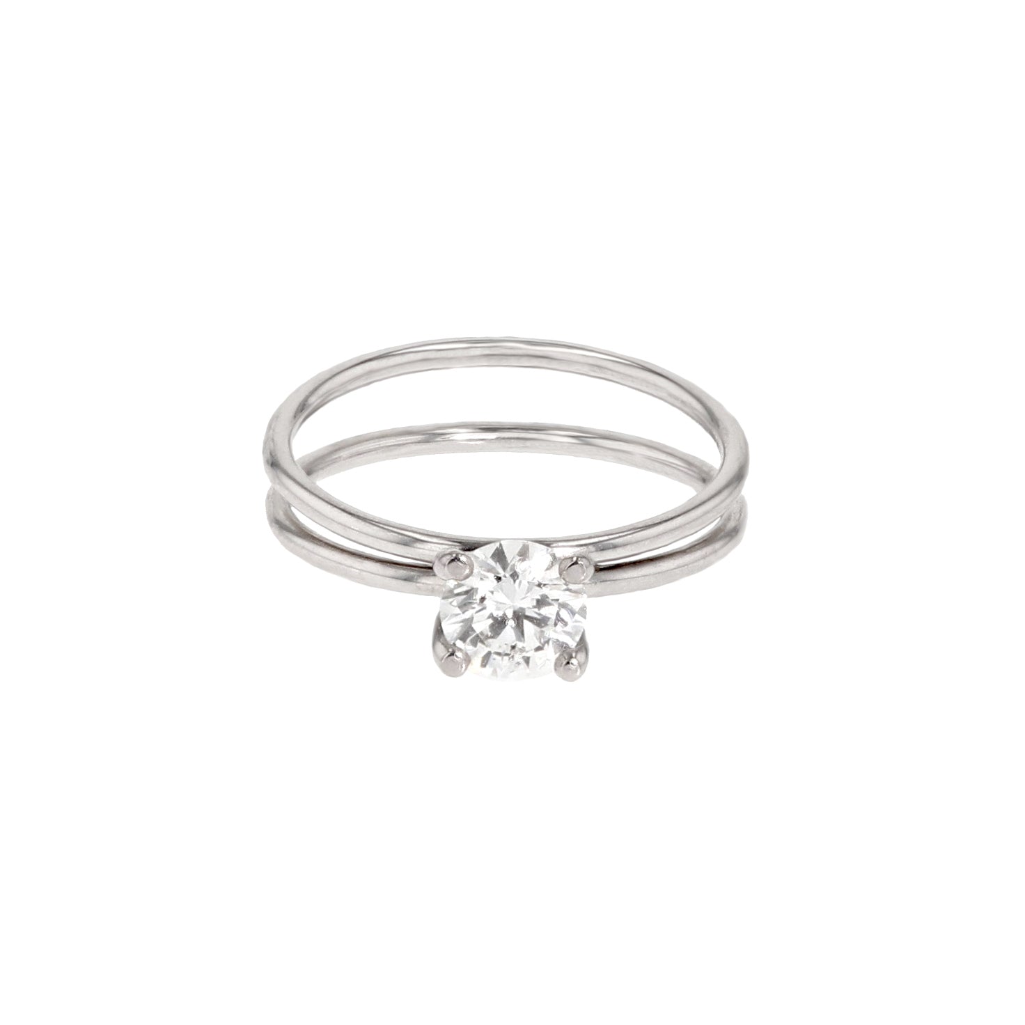 A white gold ring with a 0.07 ct. Diamond in a four prong setting. Dimensions: Weight: 2.5 g Thickness: 1.30 mm Top width: 2.5 mm Bottom width: 5.50 mm